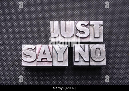 just say no phrase made from metallic letterpress blocks on black perforated surface Stock Photo