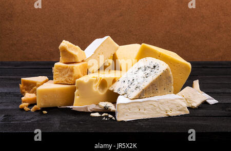 Various types of cheese on rustic wooden table Stock Photo