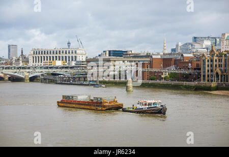 Panoramic view of Cory Riverside Energy London Reclaim tug boat pulling barge with waste containers on the River Thames as a green highway, London, UK Stock Photo