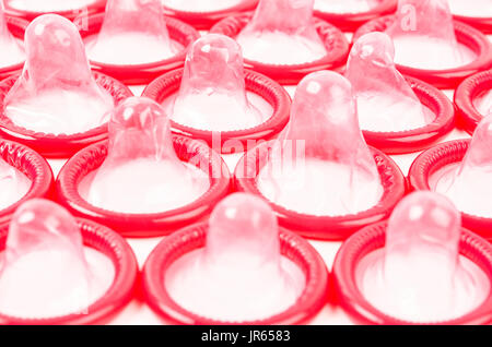 Red Condom isolated on white background. Stock Photo