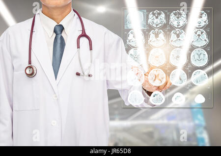 Radiologist doctor touching film brain MRI at hospital. Stock Photo