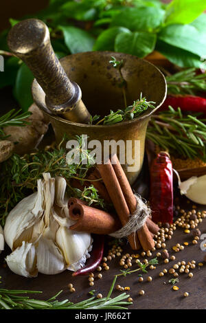 Garlic and different spices on a wooden table . Stock Photo