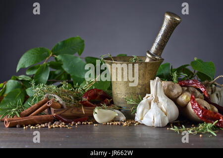 Different herbs and spices on a wooden table . Stock Photo