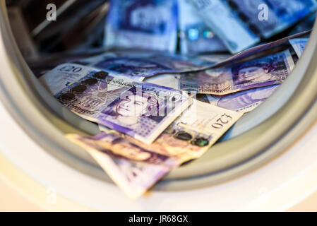 British Sterling Pounds Notes In Washing Machine. Money Laundering Concept. Stock Photo