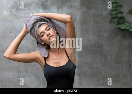 Portrait of a Young woman with a towel on her head Stock Photo