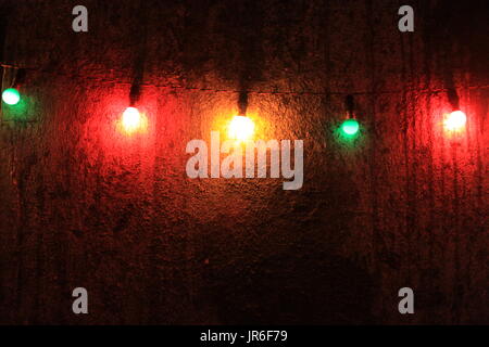 Multi-colored lights hanging on a wall Stock Photo