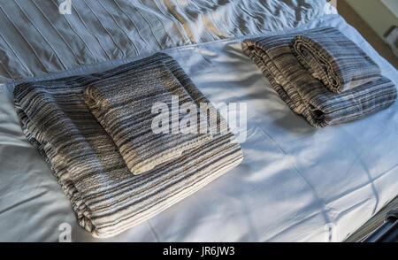 Towls on a newly laid bed. Stock Photo
