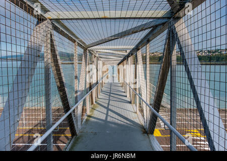 The Welsh Coast Path crossing the ferry terminal at Fishguard Harbour, Fishguard, Pembrokeshire, Wales, UK Stock Photo