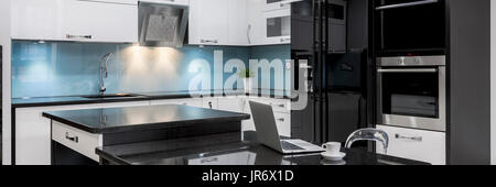 Black and white, stylish, high gloss kitchen with island, panorama Stock Photo