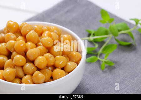 bowl of cooked chickpeas on grey place mat - close up Stock Photo