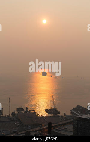 Seattle, United States. 03rd Aug, 2017. Seattle, Washington: The Port of Seattle is obscured as wildfires in Canada cloak downtown Seattle in thick haze and smoke. The reduced air quality coupled with soaring temperatures has caused an unhealthy air quality rating in the region. Credit: Paul Christian Gordon/Alamy Live News Stock Photo