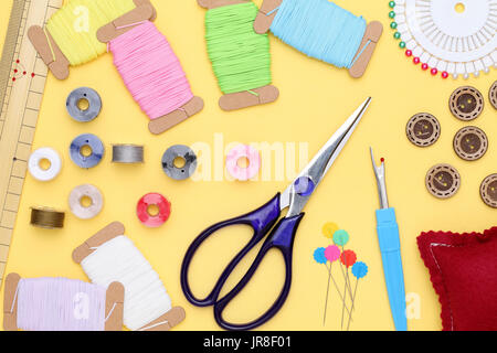 sewing tools, tailoring and fashion concept - close-up on yellow background Stock Photo