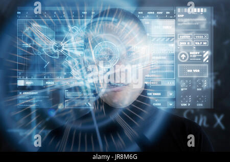 Man sneering whilst using a reality augmentation VR device with bright neon blue HUD graphical displays Stock Photo