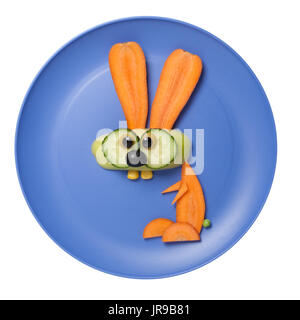 Rabbit made of raw vegetables on blue plate Stock Photo