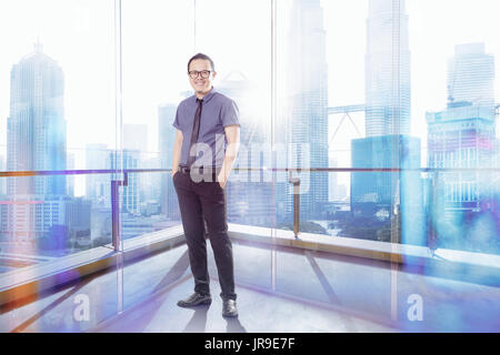Full length portrait of happy 30s 40s Asian businessman . Stock Photo