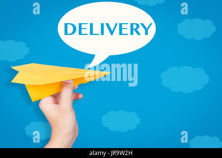 hand holding paper plane with delivery in speech bubble on blue background Stock Photo