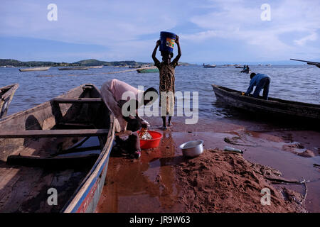 A woman washing clothes at the shore of Kibirizi fishing village in Tanganyika lake near Kigoma city in west-central Tanzania Eastern Africa Stock Photo