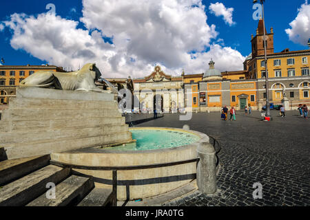Lion fountain or Fontana Dei Leoni In Piazza Del Popolo on a sunny, partly cloudy day in Rome Italy Stock Photo