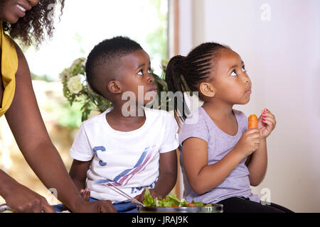 Children eating salad looking up Stock Photo