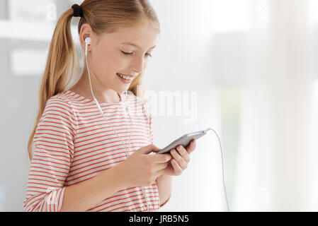 Positive minded child listening to music Stock Photo