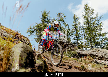 woman rider downhill mountain biking during National championship downhill Stock Photo