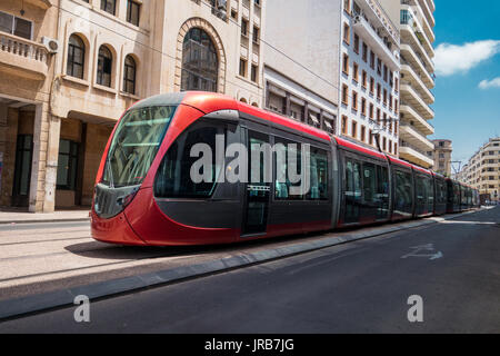 a tram passing on railways between old buildings - Casablanca - Morocco Stock Photo
