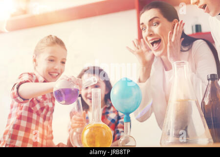 Delighted brunette waiting for reaction of reagents Stock Photo