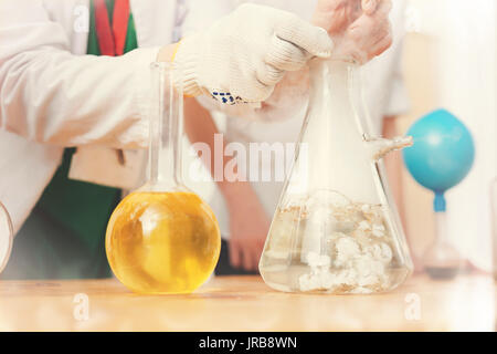 Competent scientist doing chemical experiment Stock Photo