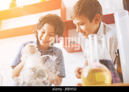 Positive pupils working together at their presentation Stock Photo