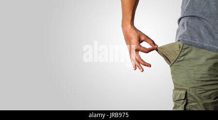 close-up of a man's hand pulling an empty pocket showing economic problems Stock Photo