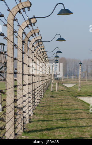 Electric barbed wire fence with lamps in Auschwitz Birkenau concentration camp in Poland, Oswiecim, Malopolska Stock Photo