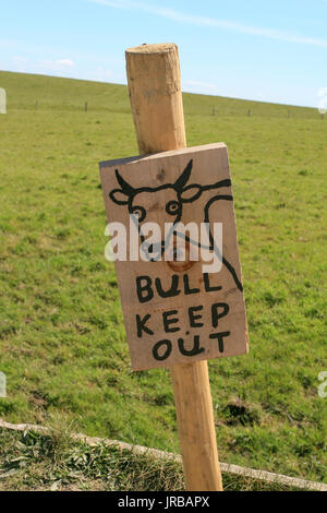 Wooden sign post, warning for tourists - bull keep out - at the Cliffs of Moher, Co. Clare,  Ireland Stock Photo