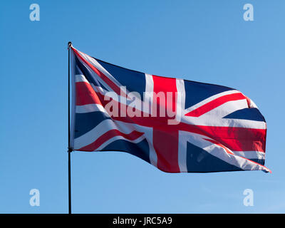 United Kingdom Union Jack Flag against a clear blue sky Stock Photo