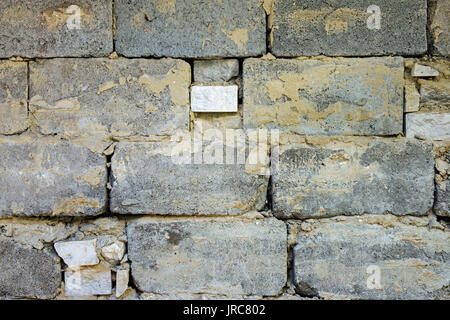 Close-up old 1950th ramshackle wall of cinder block on clay mortar as construction background. Stock Photo