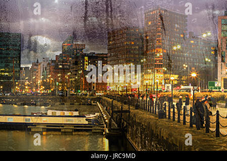 Looking through a misty window with raindrops at the nighttime buildings in Liverpool UK Stock Photo