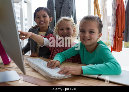 Portrait of female designers discussing over computer in creative office Stock Photo