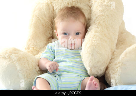 Happy baby and teddy bear looking at you Stock Photo