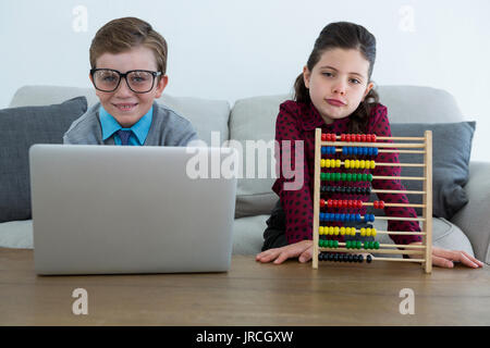 Portrait of business people working while sitting on sofa in creative office Stock Photo