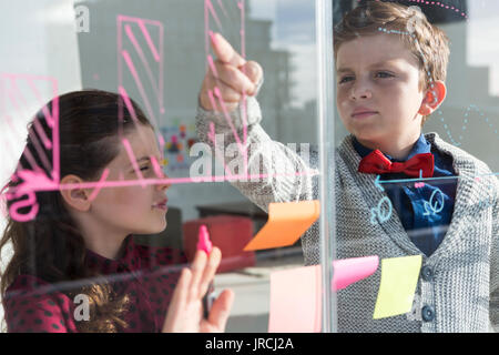Business people analyzing graph on window seen through glass Stock Photo