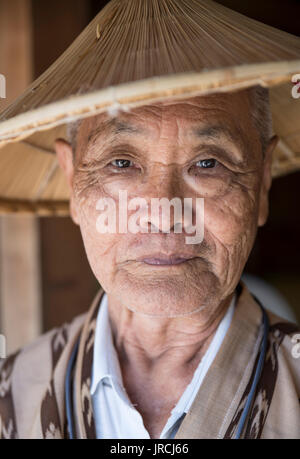 Jahana-san age 82 working at Okinawa World, Okinawa, Japan Stock Photo