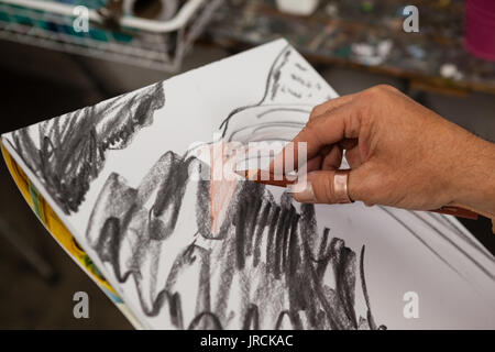 Close-up of man sketching in drawing book Stock Photo