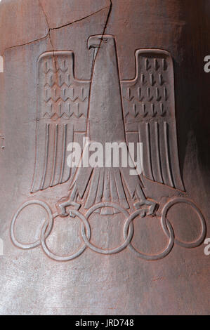 Close up of the historic 1936 Olympic Bell featuring the Reichsadler holding the Olympic Rings, Olympic stadium, Charlottenburg, Berlin, Germany Stock Photo