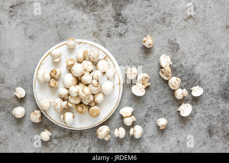 Fresh mushrooms. Raw mushrooms on wooden board. Champignons Stock Photo