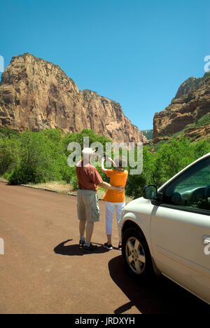 Caucasian Senior Couple (age 60-70) at Kolob Canyons at Zion National Park Springdale, Utah USA.. Caucasian female  taking photo, Stock Photo