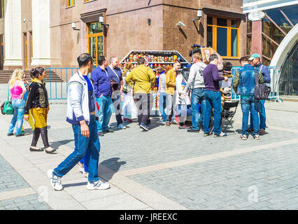 MOSCOW, RUSSIA - MAY 11, 2015: The outdoor stall offers wide range of russian souvenirs such as matryoshka doll, fur hats and soviet military caps, on Stock Photo