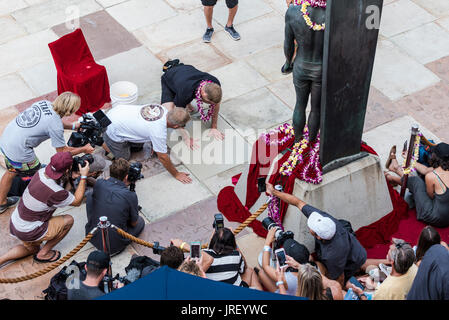 Huntington Beach, USA. 04 August, 2017. Surfer and three time world champion Mick Fannig (AUS) castgs his feet and handprints into the cement plaza outside of Huntington Surf and Sport during his induction ceremony to the Surfing Hall of Fame. Credit: Benjamin Ginsberg/Alamy Live News. Stock Photo