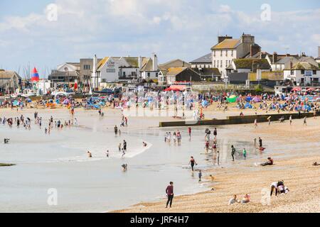 Lyme Regis, Dorset, UK.  5th August 2017.  UK Weather.  Sunbathers on the beach enjoying the morning sunhine at the seaside resort of Lyme Regis in Dorset.  Photo Credit: Graham Hunt/Alamy Live News Stock Photo