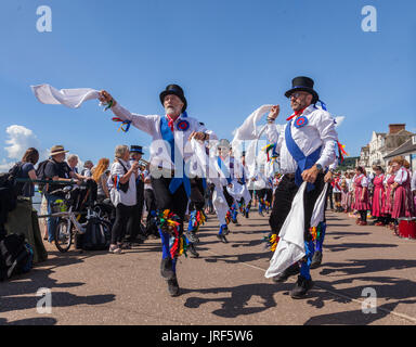 Sidmouth, 5th Aug 17. Morris Men perform on the seafront at Sidmouth during the Folk Week Festival. The folk festival has been running since 1955, attracts tens of thousands of visitors, and will see over 700 events before the final concert on the 11th August.Credit: South West Photos / Alamy Live News Stock Photo