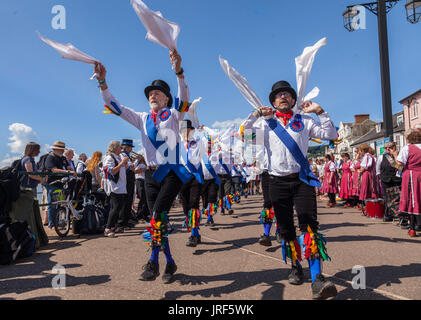 Sidmouth, 5th Aug 17. Morris Men perform on the seafront at Sidmouth during the Folk Week Festival. The folk festival has been running since 1955, attracts tens of thousands of visitors, and will see over 700 events before the final concert on the 11th August.Credit: South West Photos / Alamy Live News Stock Photo