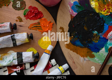 High angle view of tubes on color palette in art class Stock Photo